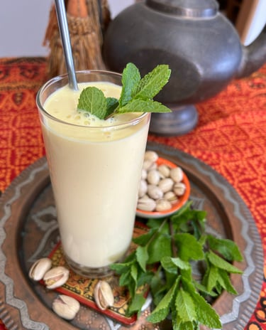 mango lass with nuts and mint leaves on copper plate