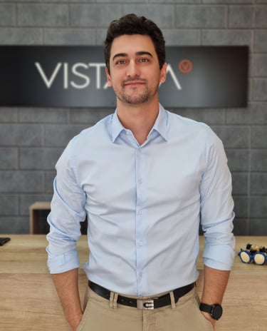 a man in a blue shirt and tan pants