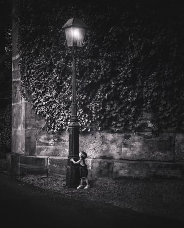 Fine art photograph a little boy looking at a lamp post 