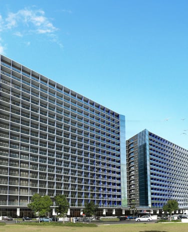 a large building with a lot of windows and a lot of cars