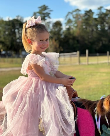 Preschool princess feeling confident in the saddle at a pony ride party