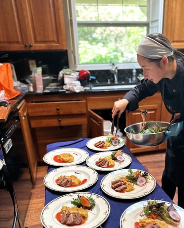 Chef mia plating seared duck, truffle infused root mash, plum gastrique for private chef dinner