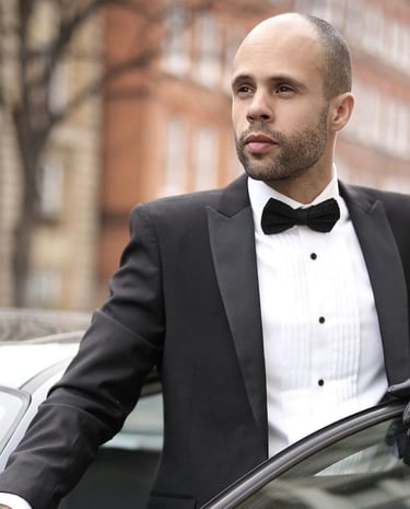 a man in a tuxedo suit and gloves