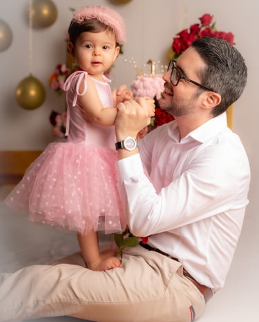 a man and a little girl in a pink dress