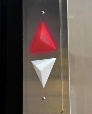 arrow indicators inside the elevator showing the elevator is going up by lighting the UP arrow red