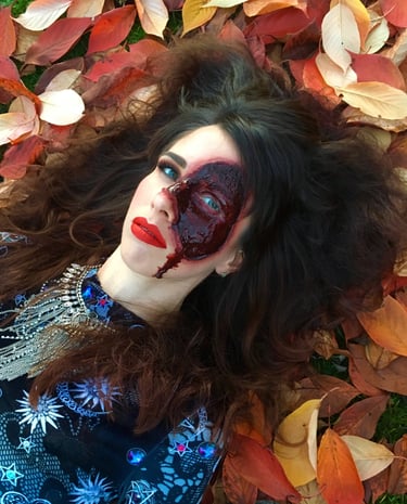 a woman with a bloody face created with special effects makeup