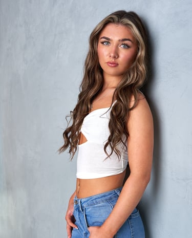 A model in a white crop top and jeans