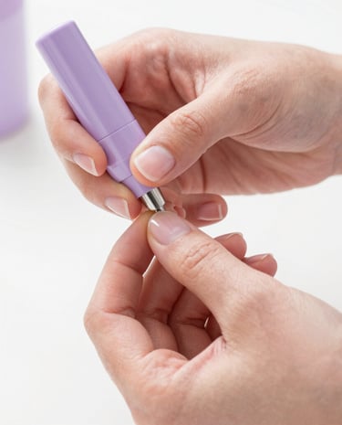 Close-up of hands performing a precise manicure technique, soft natural lighting, pastel violet and pink tones, clean white background, shallow depth of field, 35mm photography