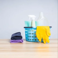 Cleaning supplies in a basket on a table neatly organized