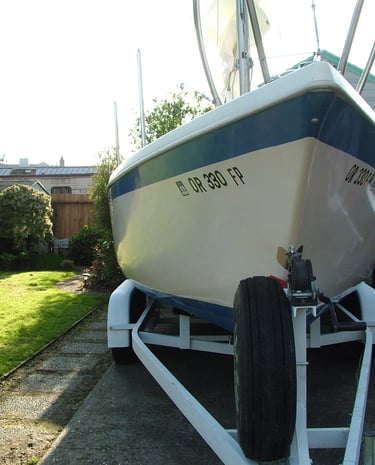 a boat sitting on a trailer trailer with a trailer attached to it