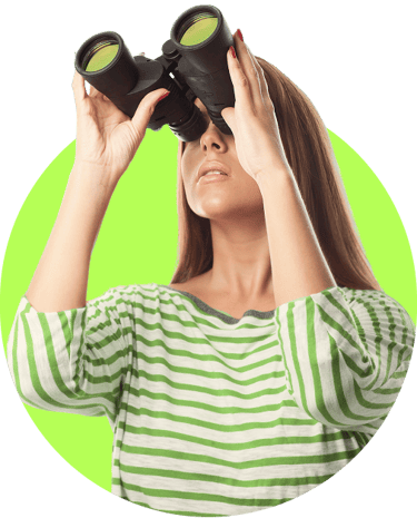 a woman looking through binoculars at a green screen