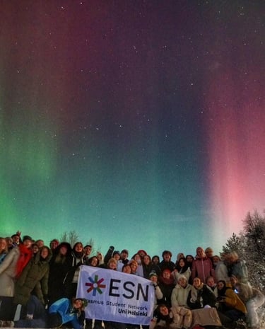 a group of people standing in front of a green and purple sky