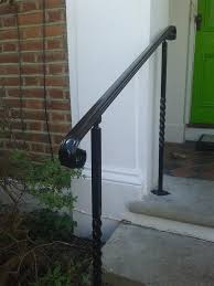 a white staircase with a black modern handrail