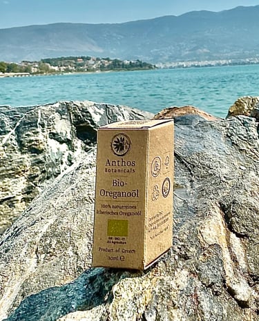 a box of oregano essential oil sitting on a rock
