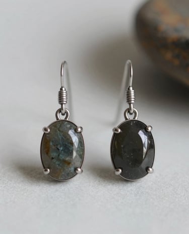 Finished handmade earrings displayed on a rustic wooden table.