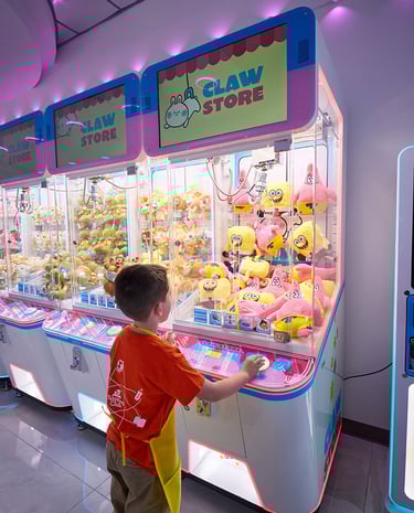 Young Boy playing claw machines