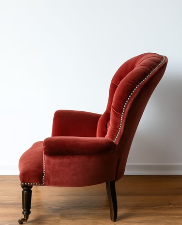 Red velvet vintage armchair with curved backrest