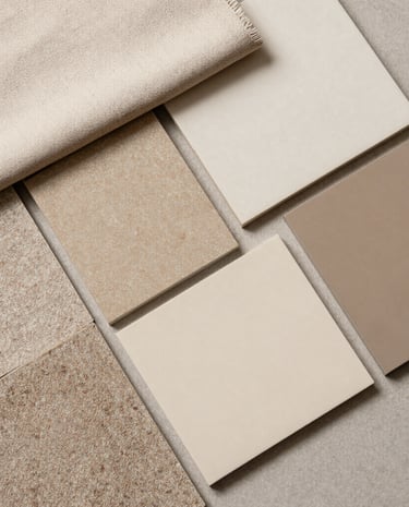 Close-up of hands arranging fabric swatches and color samples for an interior project.