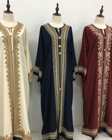 A beautifully arranged boutique interior showcasing kaftans and evening gowns in rich navy and gold tones.