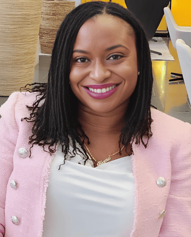 a woman in a pink jacket and white shirt