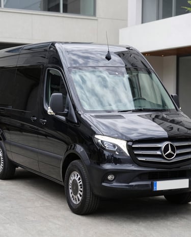 Professional driver assisting passengers with luggage at a mosque entrance.