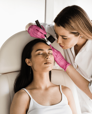 Dermatologist performing a facial skin examination using a dermatoscope during skin cancer screening