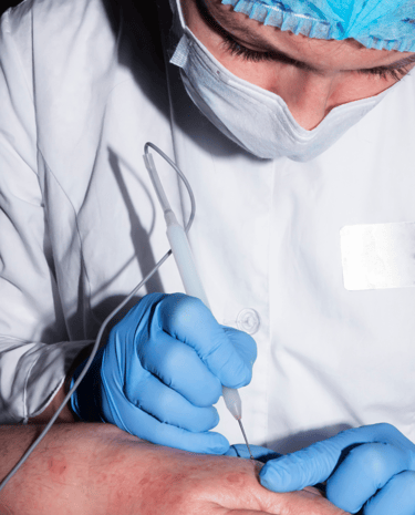 Dermatologist performing Mohs surgery to remove skin cancer while preserving healthy tissue.