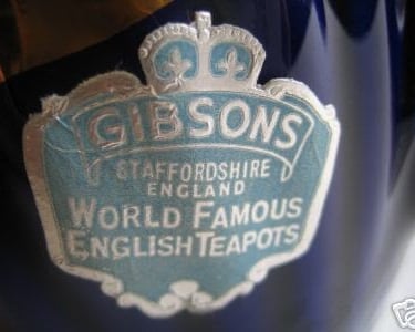 Vintage Gibsons Staffordshire England label on a blue ceramic teapot with silver crown logo.