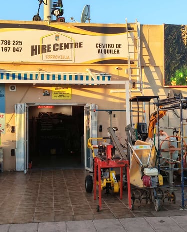 Hire Centre Torrevieja storefront with mobility scooters, cement mixers, and construction equipment for rent.