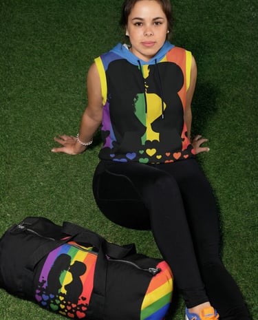 a woman sitting on the grass with gym bag and sleeveless hoodie with silhouettes of lesbian kissing