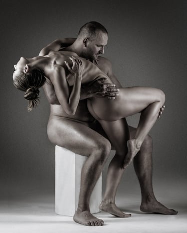 a naked couple is in pose with the male holding up the female