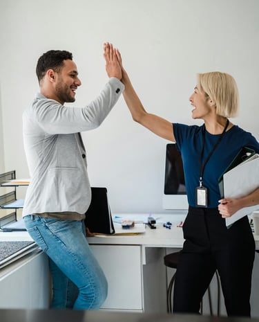 a man and woman giving each other high five fingers