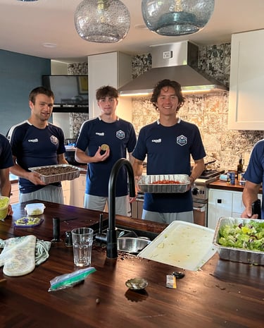 Midlakes soccer players showing off the meal they have prepared for The Sophia Way.