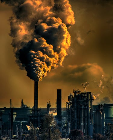 a large amount of smoke billowing out of a fossil fuel factory