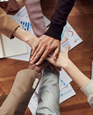 a group of people holding hands in a circle