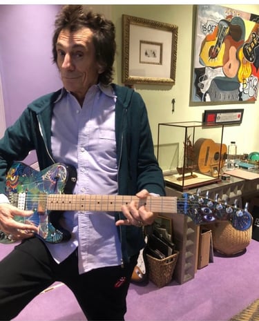 Ronnie Wood of the Rolling Stones singing - autographing my painted guitar.