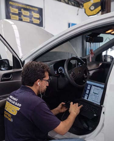 Mecânico realizando diagnóstico automotivo com equipamento profissional em oficina de São José do Ri