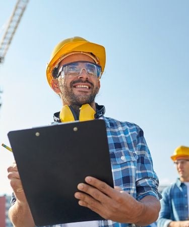 a man in a yellow helmet and a man in a yellow helmet