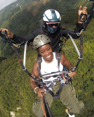 a man and woman are parasailing in the air
