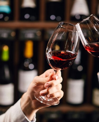 Two wine glasses clinking