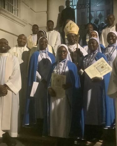 A group of Catholic clergy, nuns in blue habits, and a bishop standing on steps after a church ceremony.