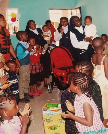 Catholic nuns and African children celebrating together in a joyful community gathering or school event.