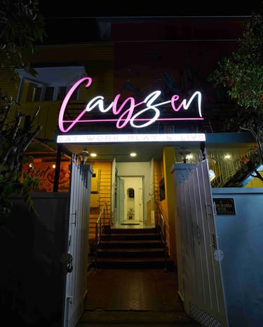 a neon sign that says,'Cayzen'
