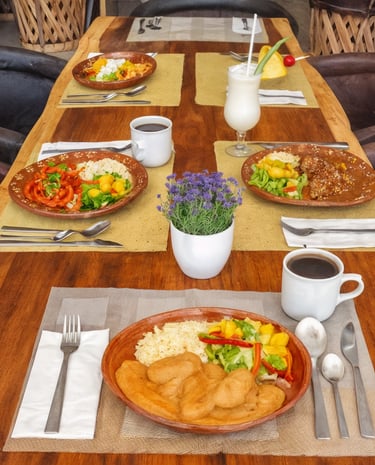 a table with plates of food and drinks