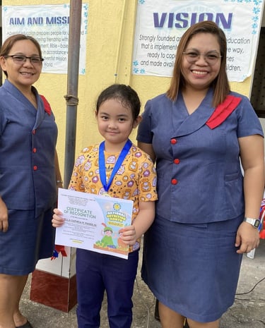  Elementary Student holding a certification with a teacher