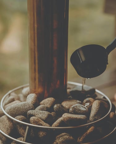 Close-up of Scandinavian sauna stove with hot stones in an Outdoor sauna Ontario interior