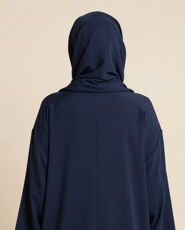 A cozy, inviting corner with folded mastour clothing pieces arranged neatly on shelves.