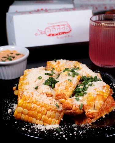 a plate of food with a slice of corn on it