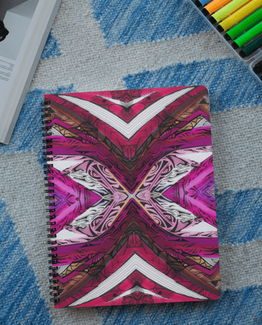 a notebook with a pink and white design
