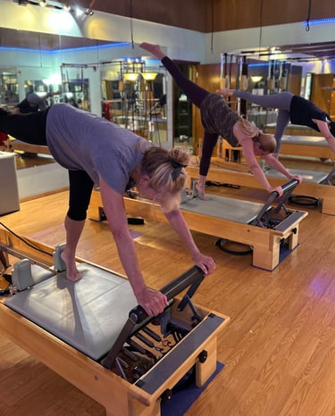 three women doing pilates